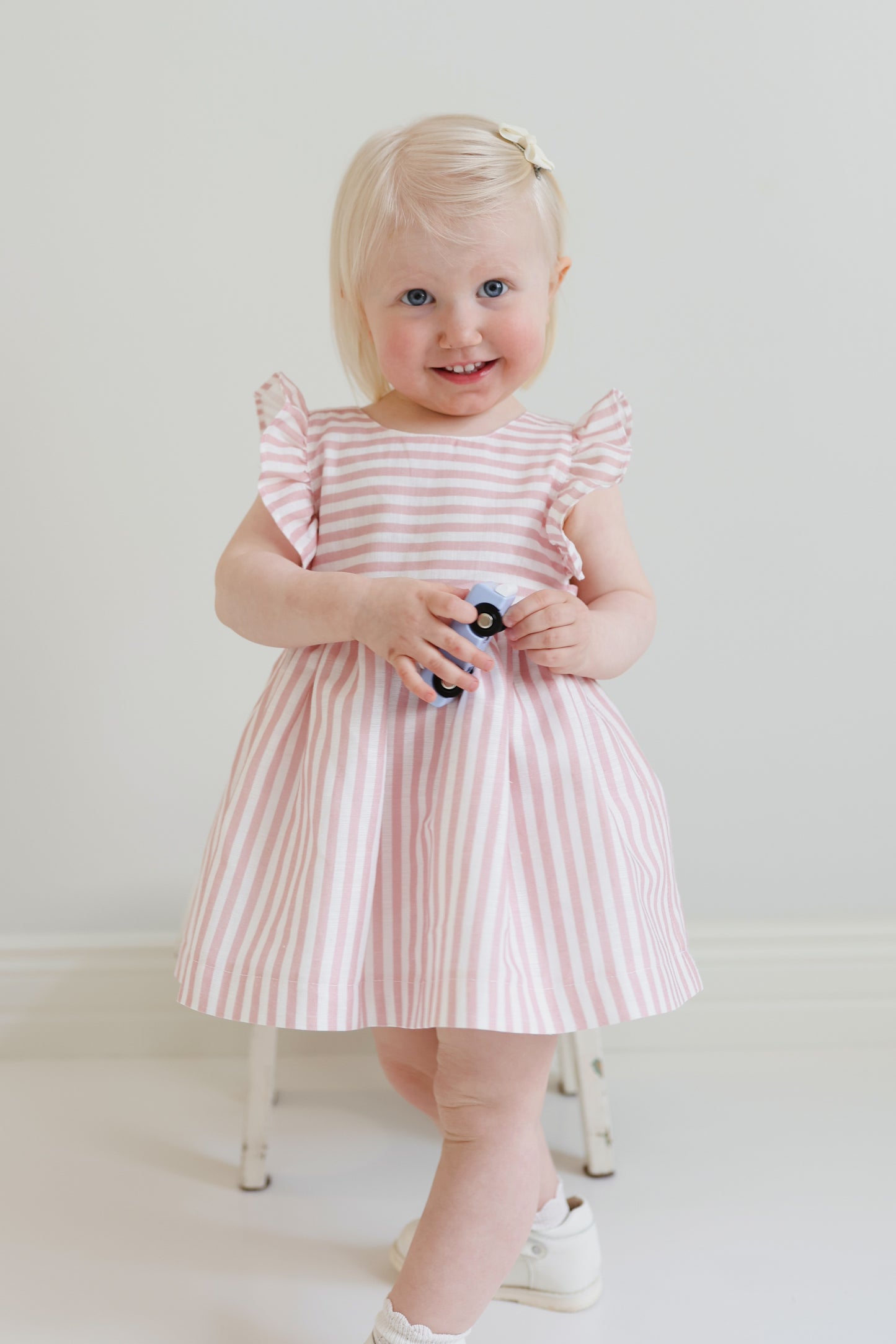 Dulci bow dress in striped blush linen