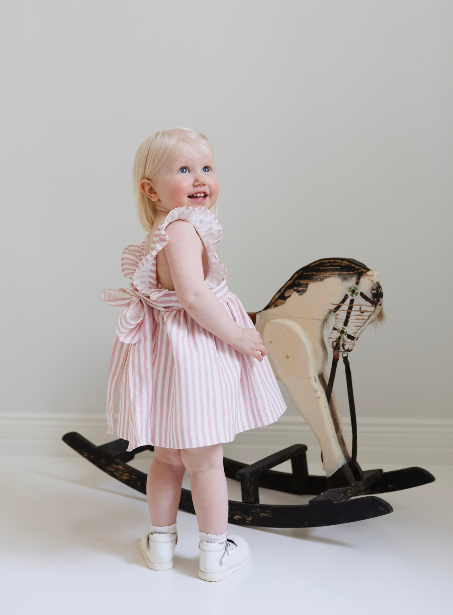 Dulci bow dress in striped blush linen