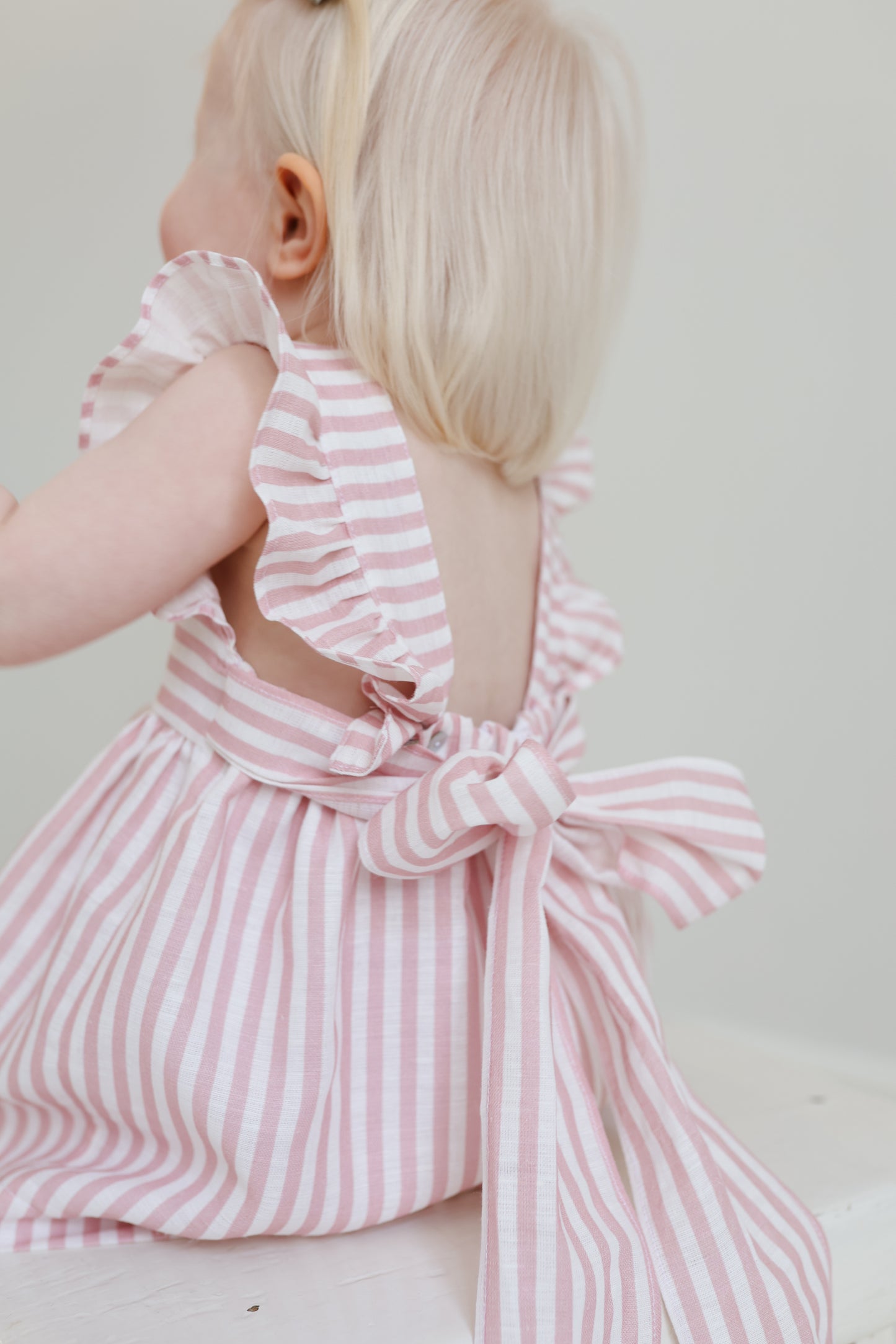 Dulci bow dress in striped blush linen